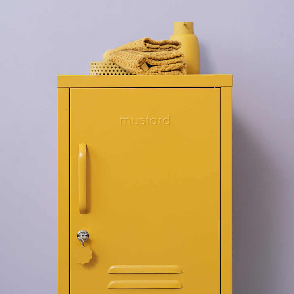 Yellow locker with 'mustard' branding against a purple background