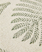 Close-up of a textured fabric with green leaf pattern