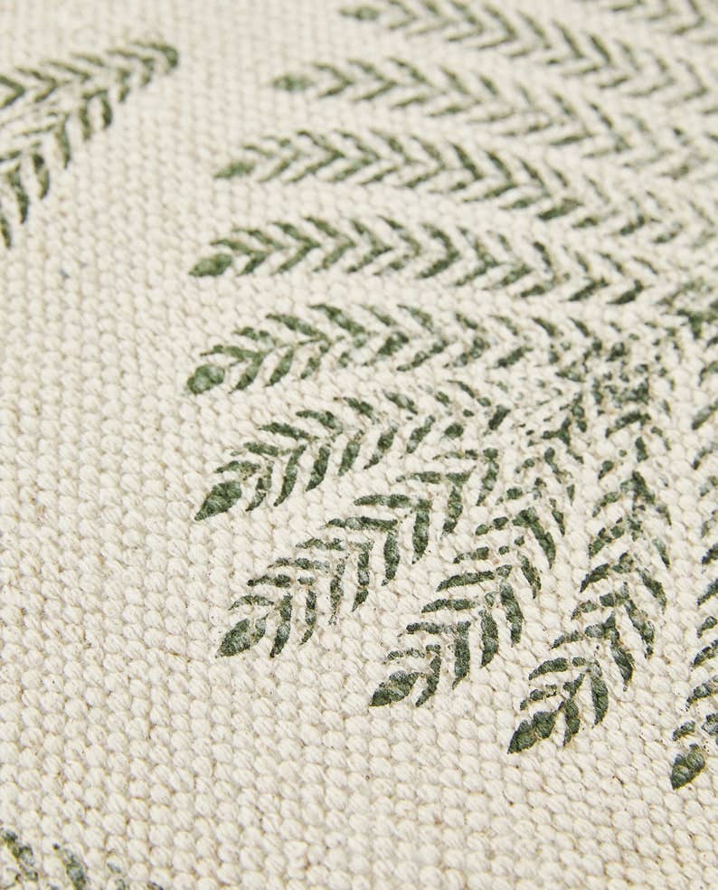 Close-up of a textured fabric with green leaf pattern