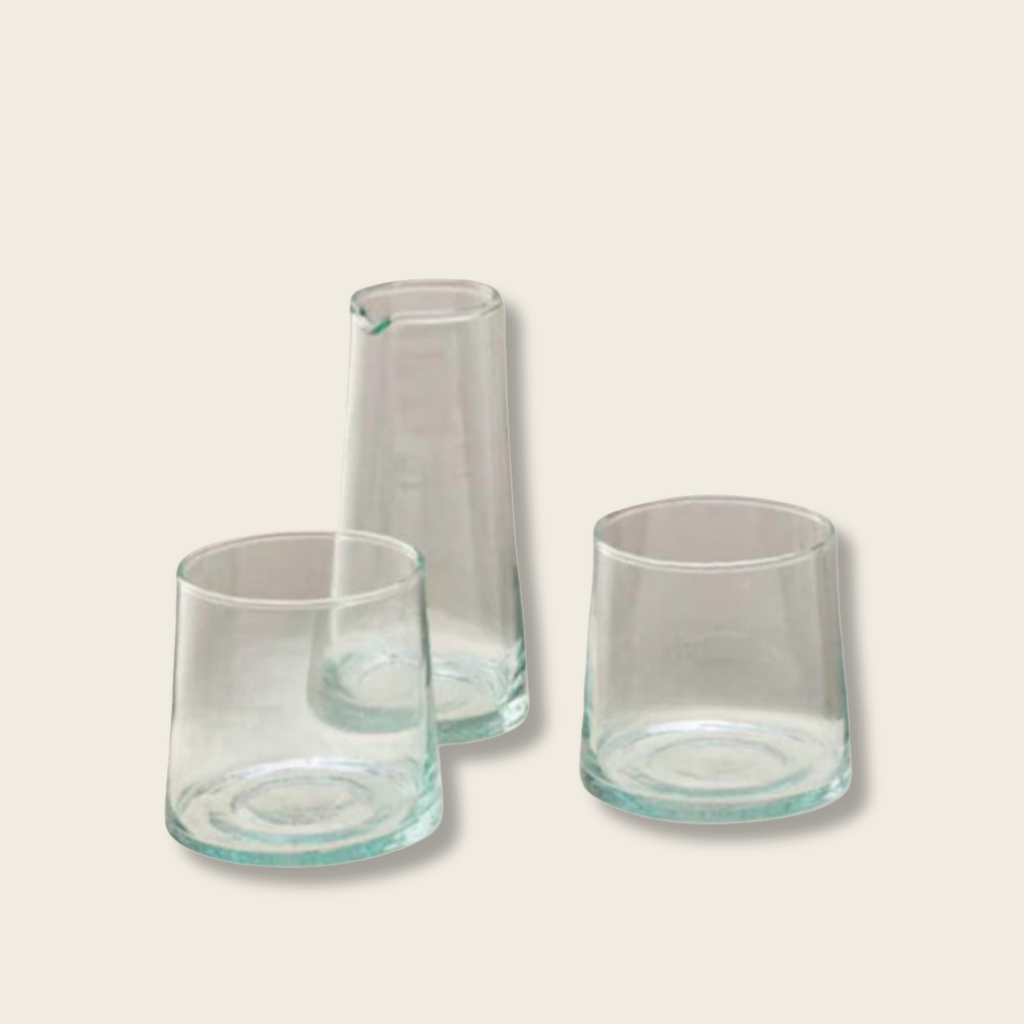small carafe and two low glasses on a beige background