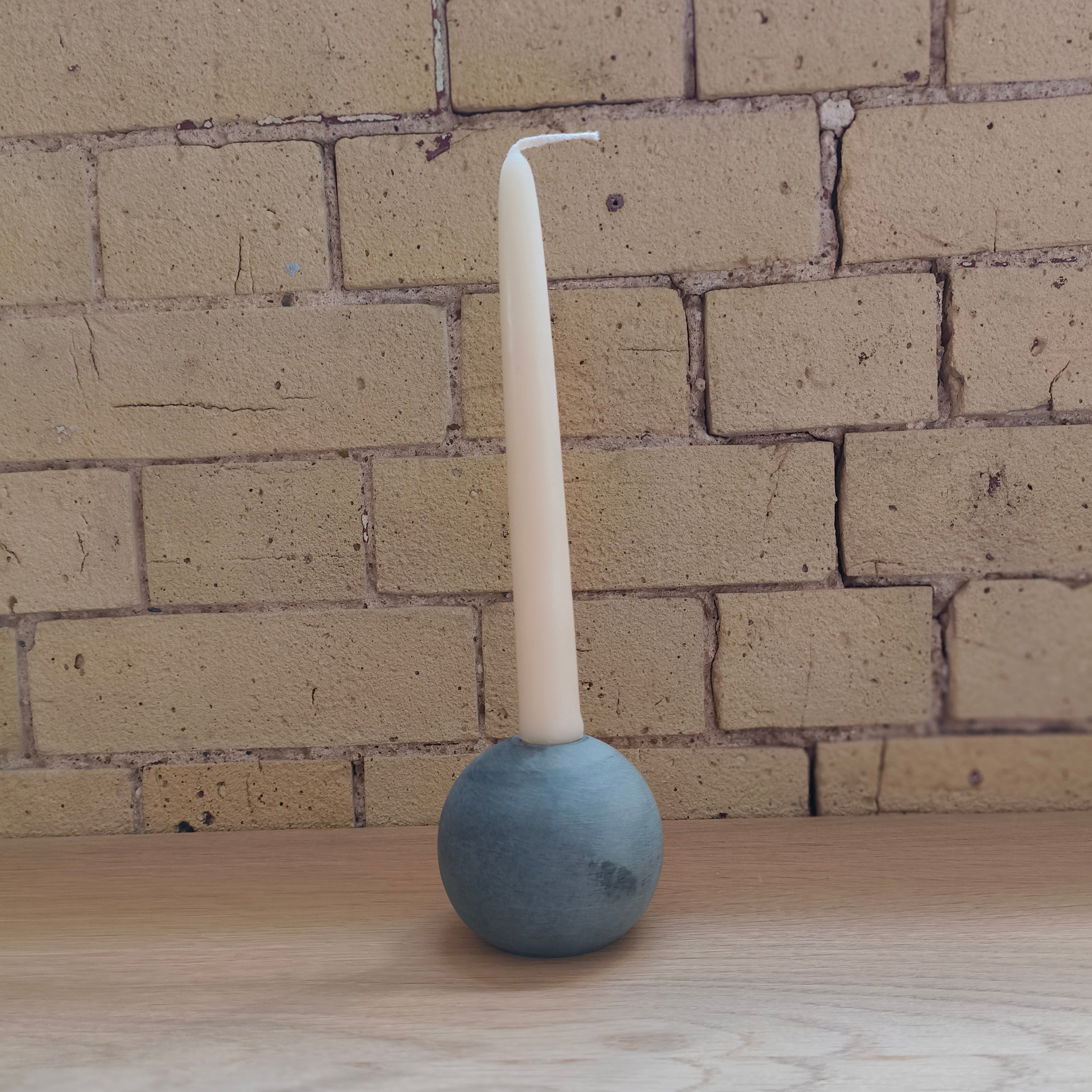 ball of stone candle holder and candle grey