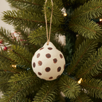 Decorative hanging ball with brown spots on a white background