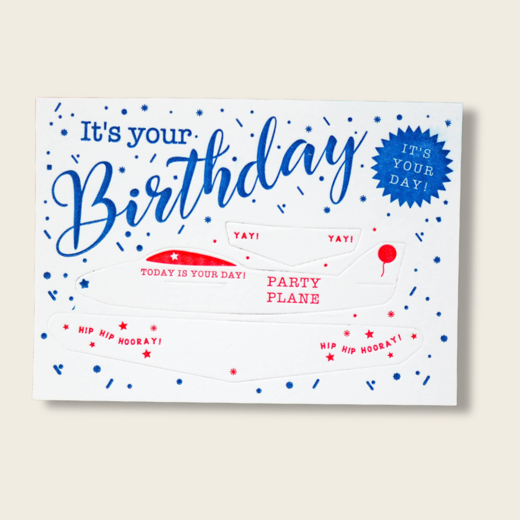 Birthday card with blue text and red accents on a white background
