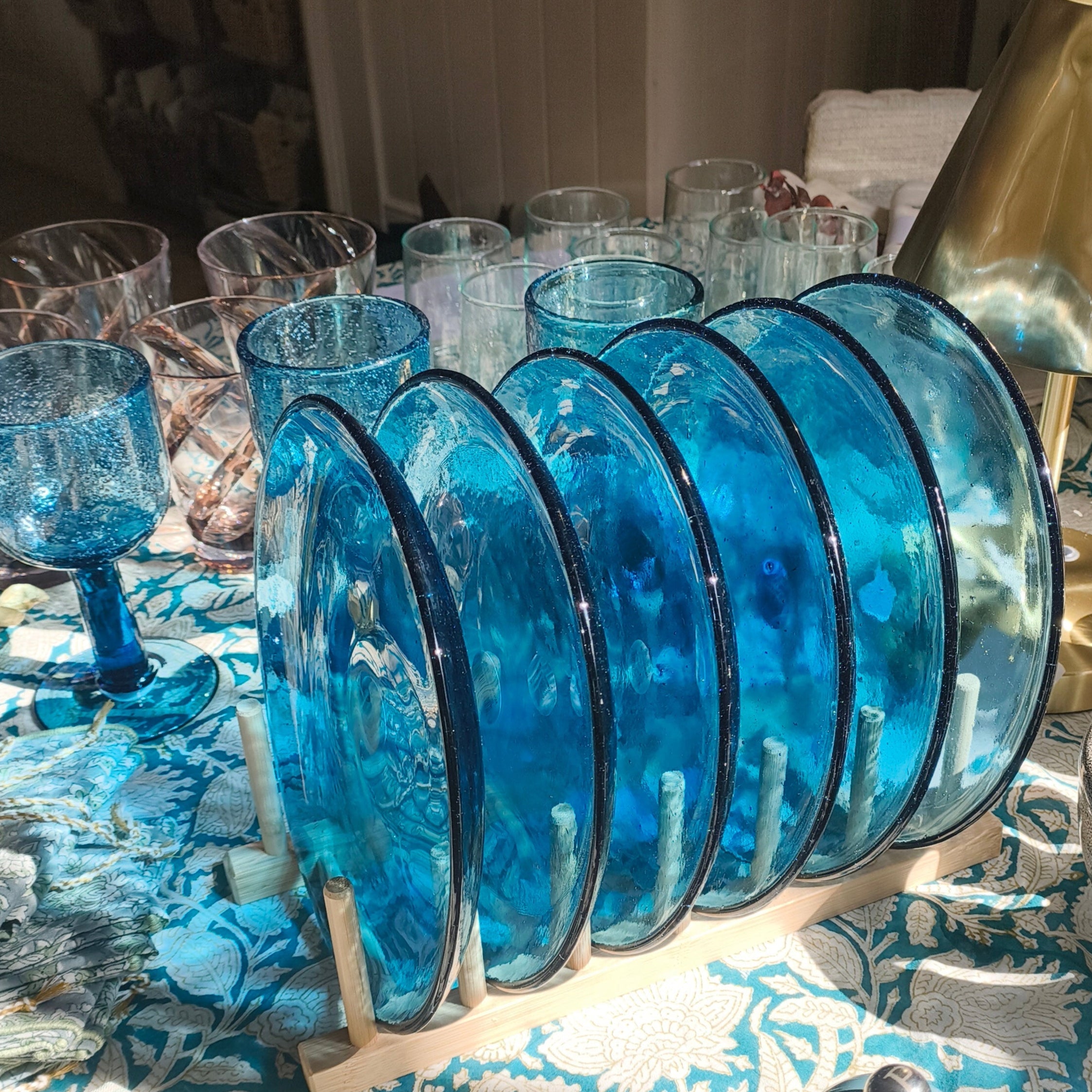 Blue glassware on a table with a textured tablecloth