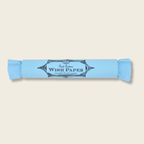 Roll of wish paper with a blue wrapper on a beige background