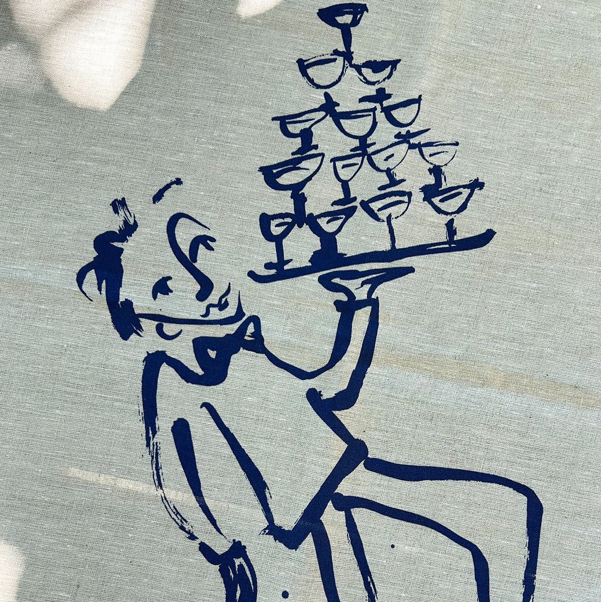 Blue ink drawing of a waiter carrying a tray with glasses on a textured beige background