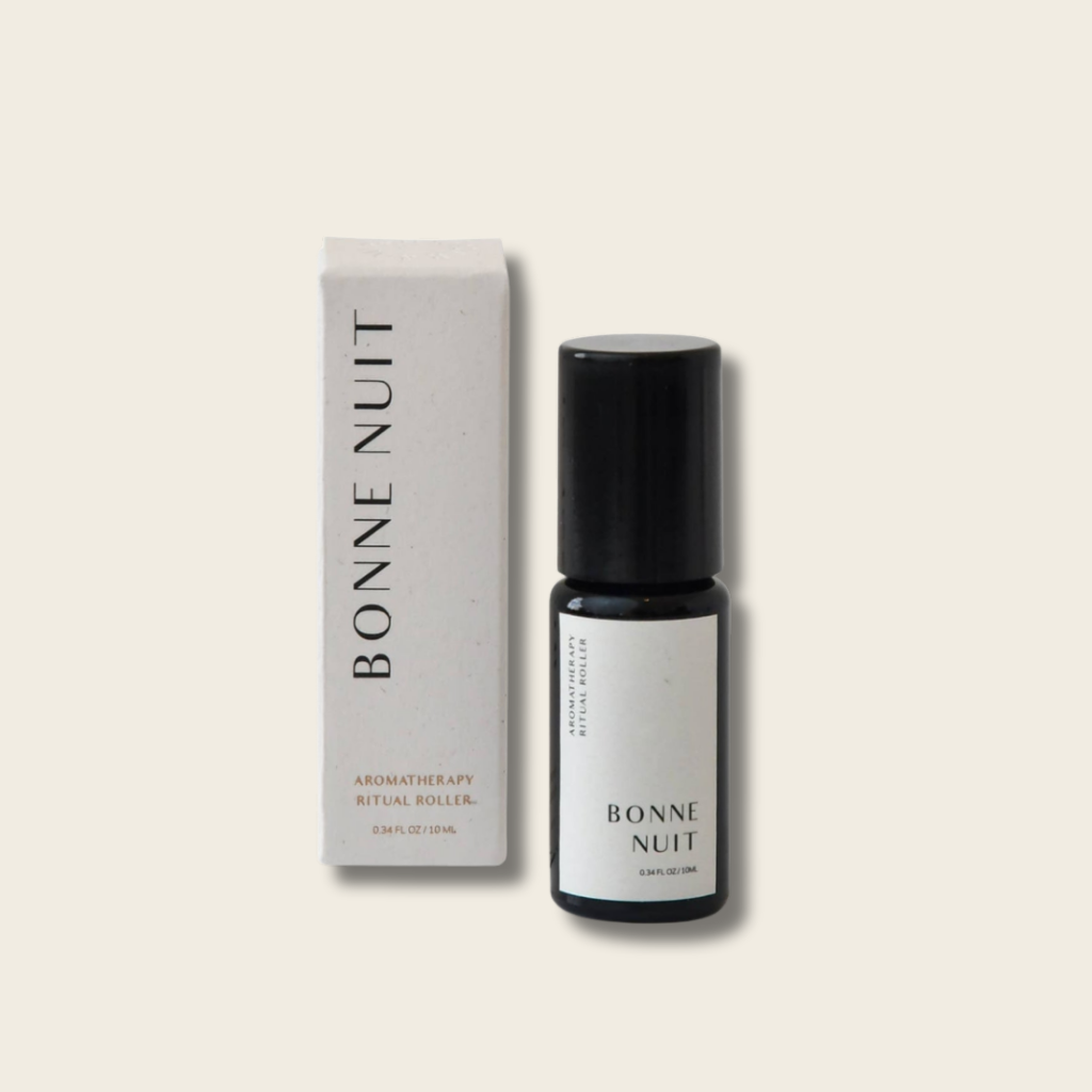 Bottle and box of 'Bonne Nuit' aromatherapy roller on a beige background