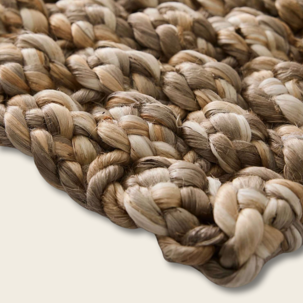 Close-up of braided rope with natural color variations on a light background