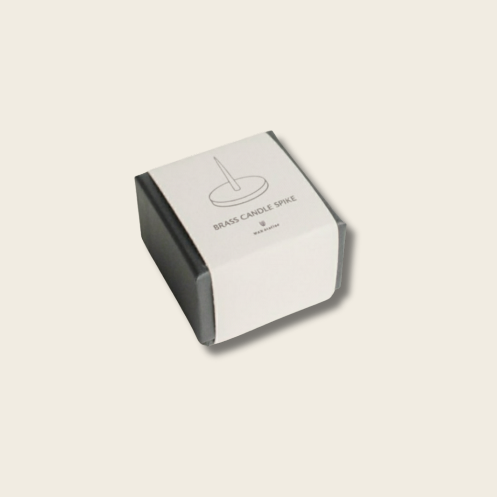 box with words 'brass candle spike' on a beige background
