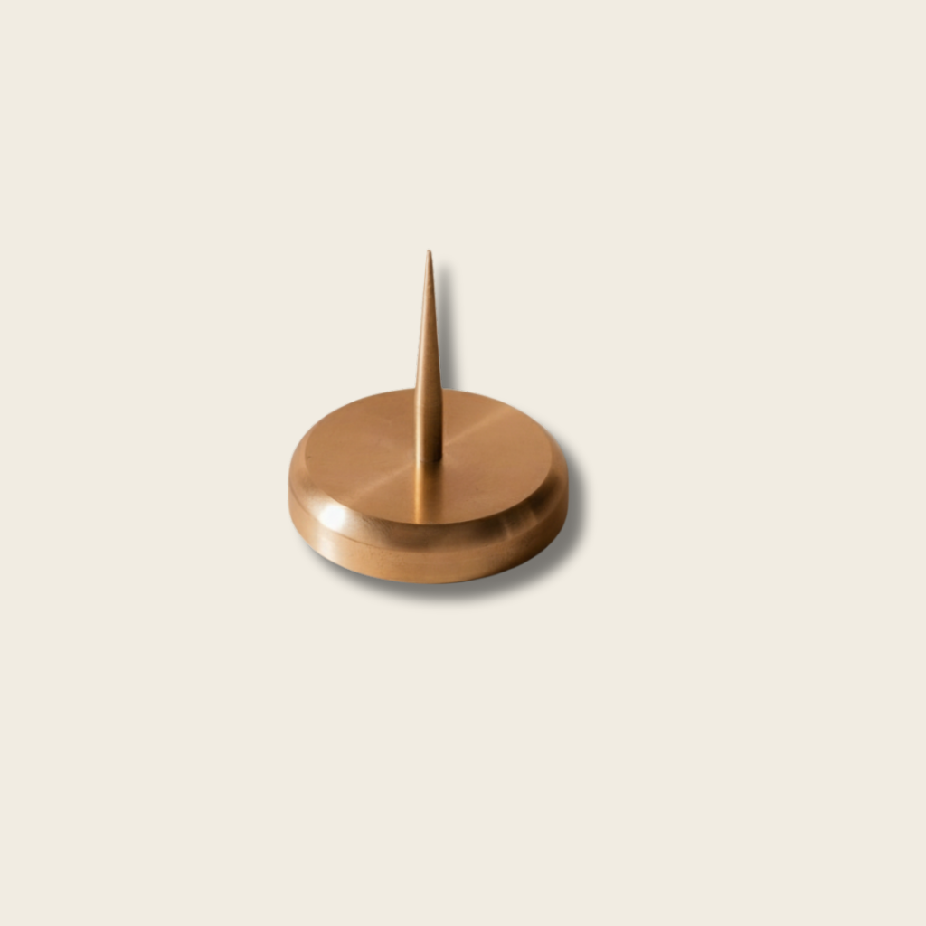Brass Candle Spike on a beige background