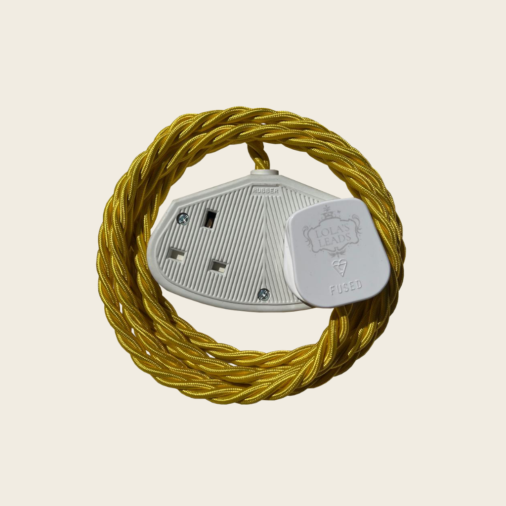 Yellow electrical plug with a coiled yellow cable on a beige background
