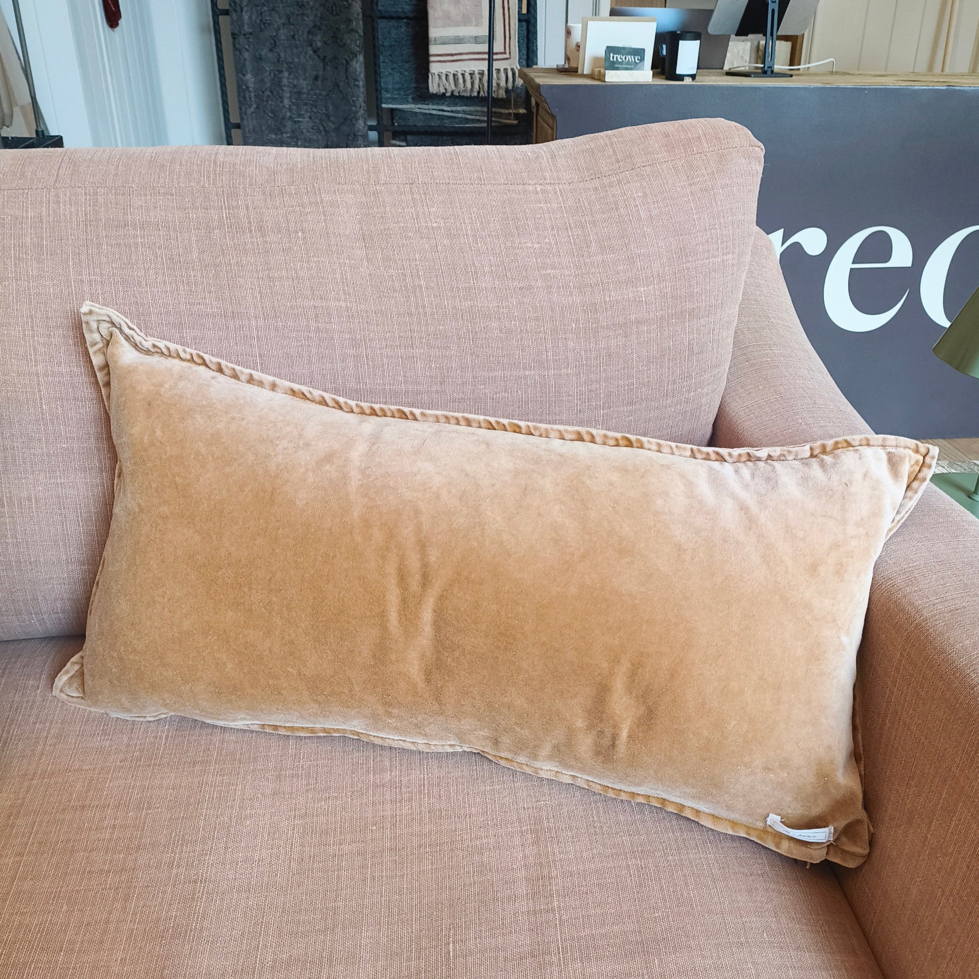 caramel coloured velvet cushion on dusk pink linen sofa