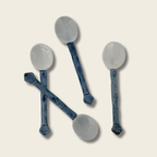 four blue and white ceramic teaspoons