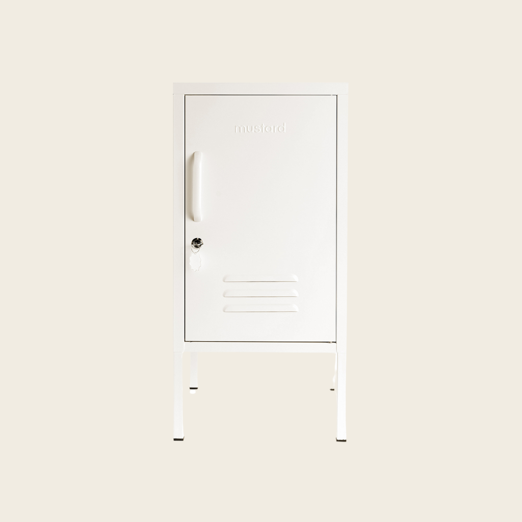 White cabinet with a handle on a light beige background