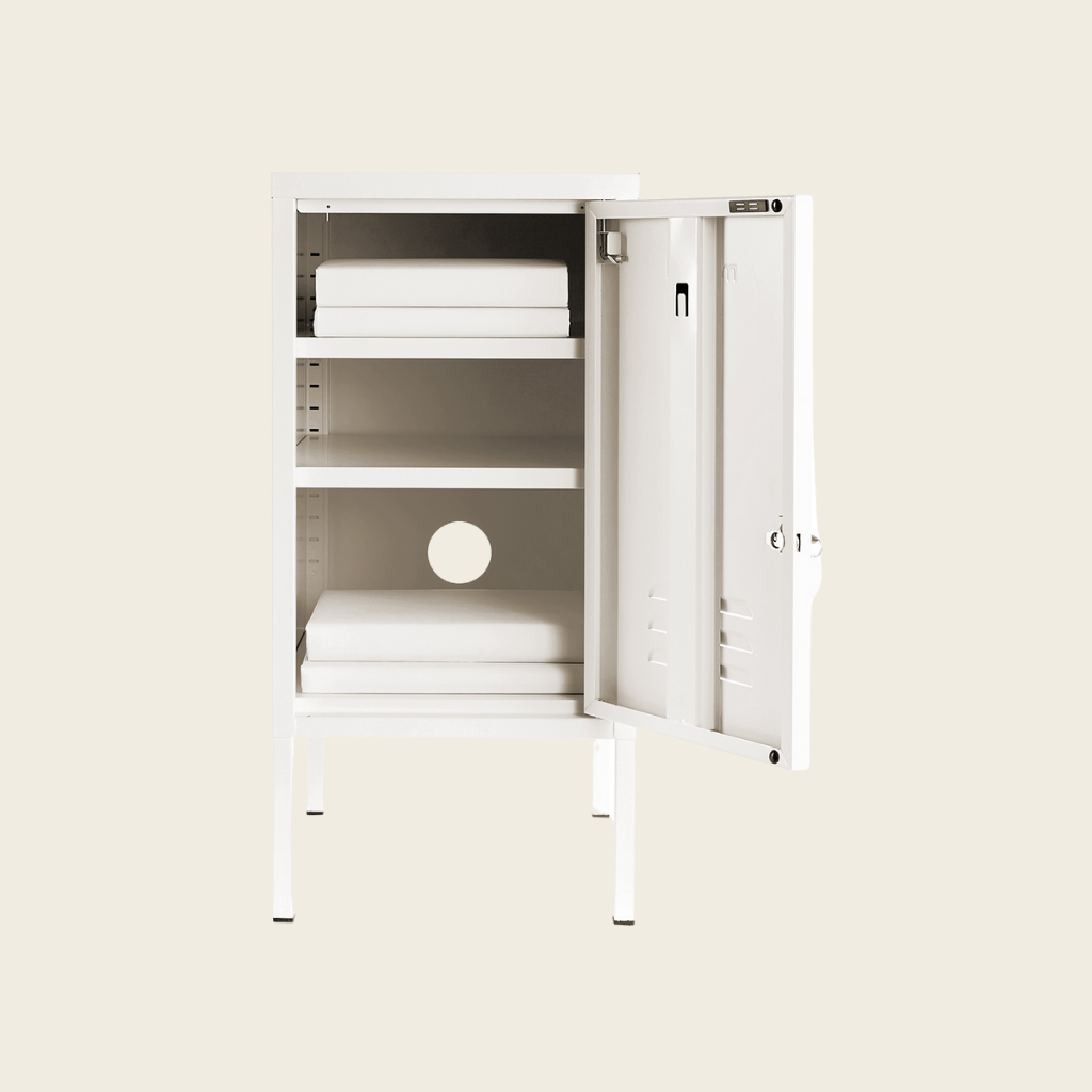 White storage cabinet with open doors on a beige background