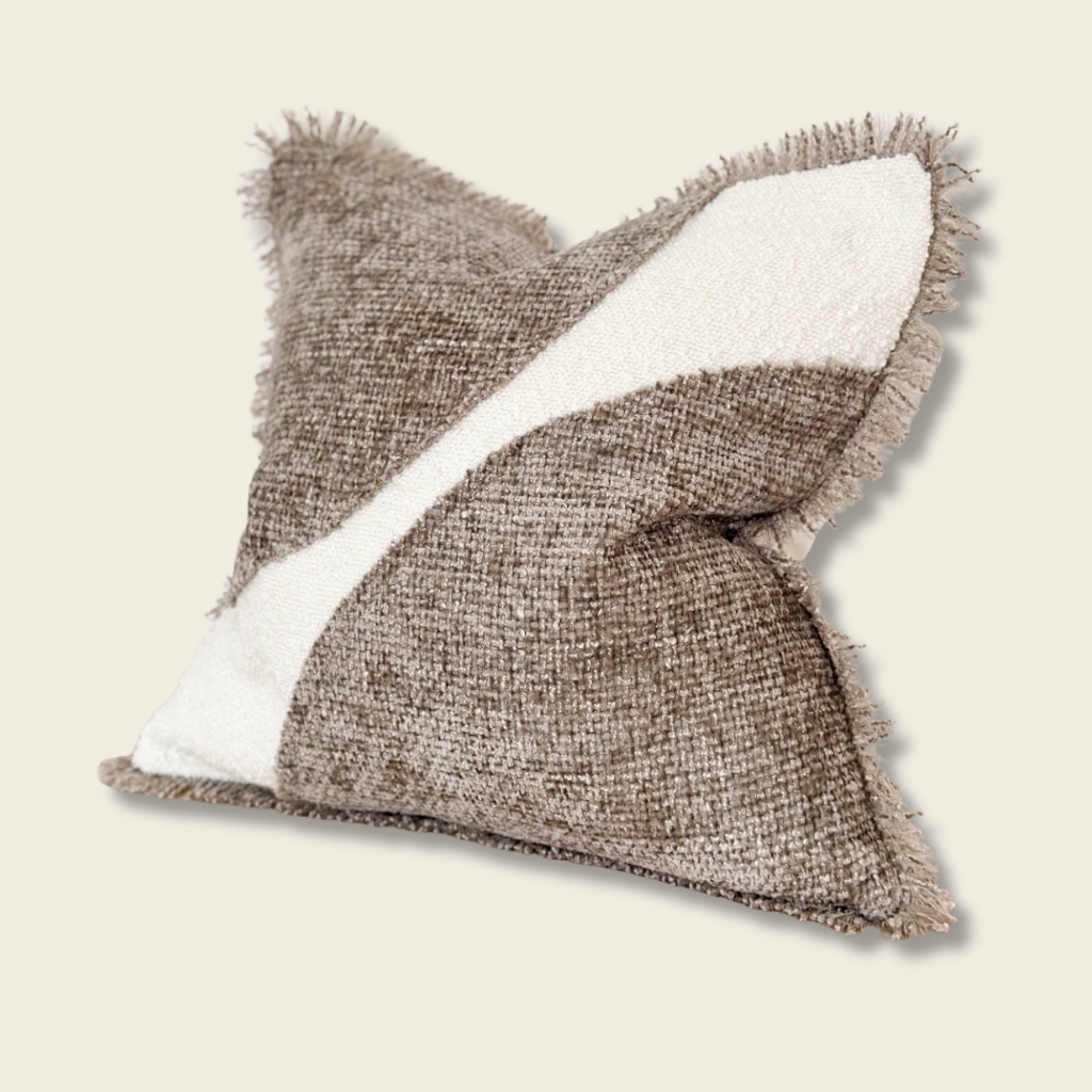 cream and brown chenille cushion with frayed edges on a beige background