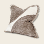 cream and brown chenille cushion with frayed edges on a beige background