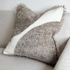 Textured pillow with a geometric pattern on a light-colored sofa.