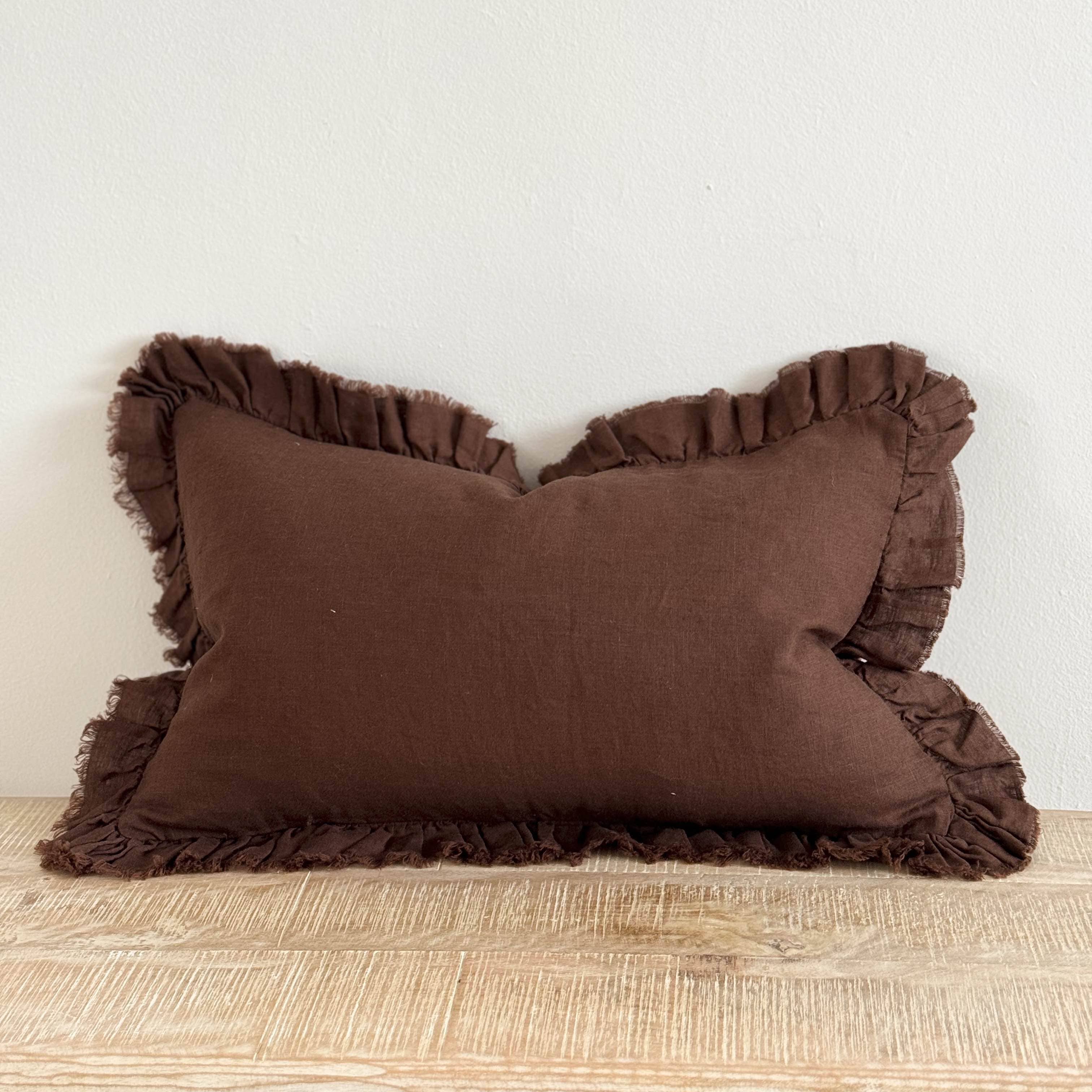 brown linen cushion with ruffle edges