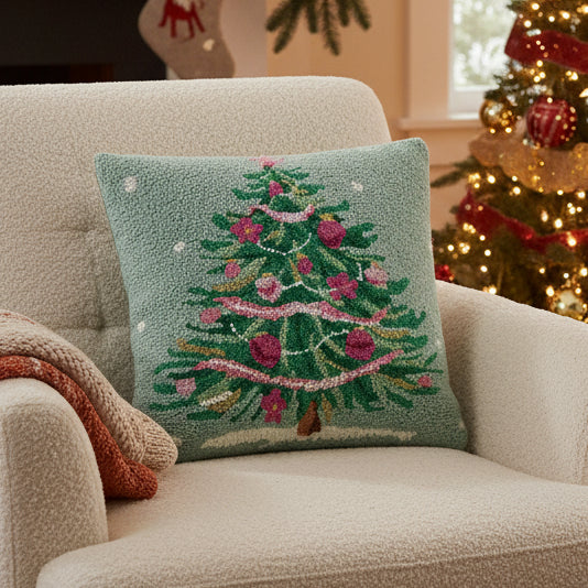 Decorative pillow with a Christmas tree design on a light blue background
