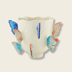ceramic ase with butterflies protruding from edges
