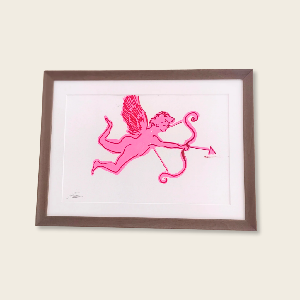 Framed artwork of a pink cherub with bow and arrow on a white background