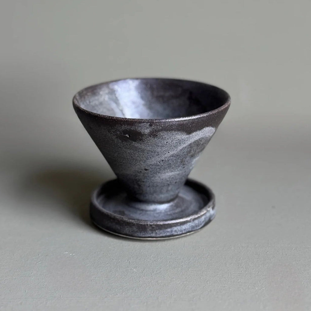 Black ceramic cup on a gray background