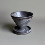 Black ceramic cup on a gray background