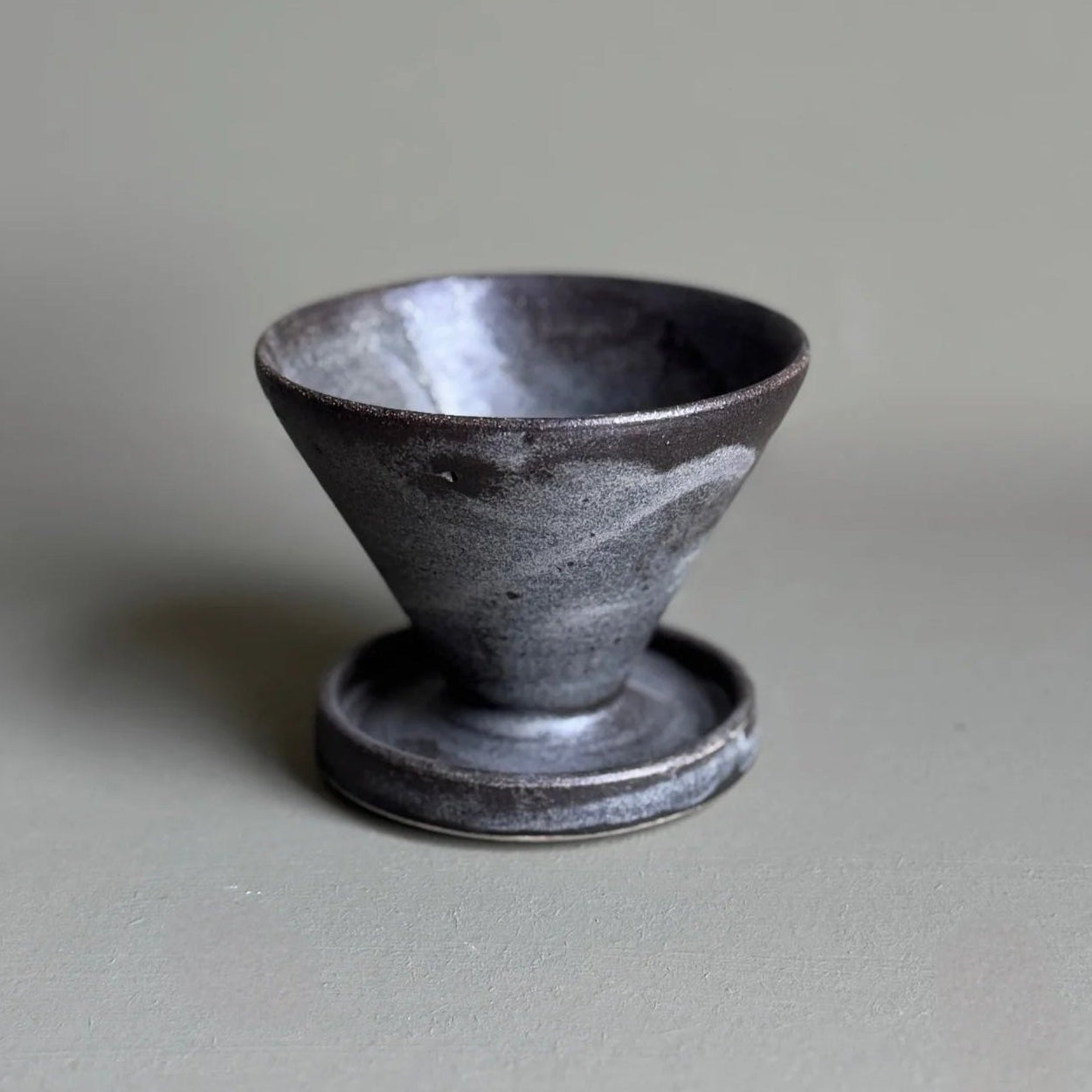 Black ceramic cup on a gray background