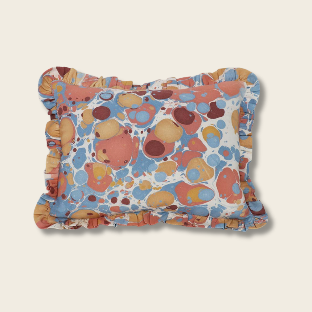 Colorful patterned pillow on a beige background