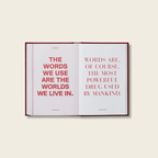 Open book with red text on a light beige background