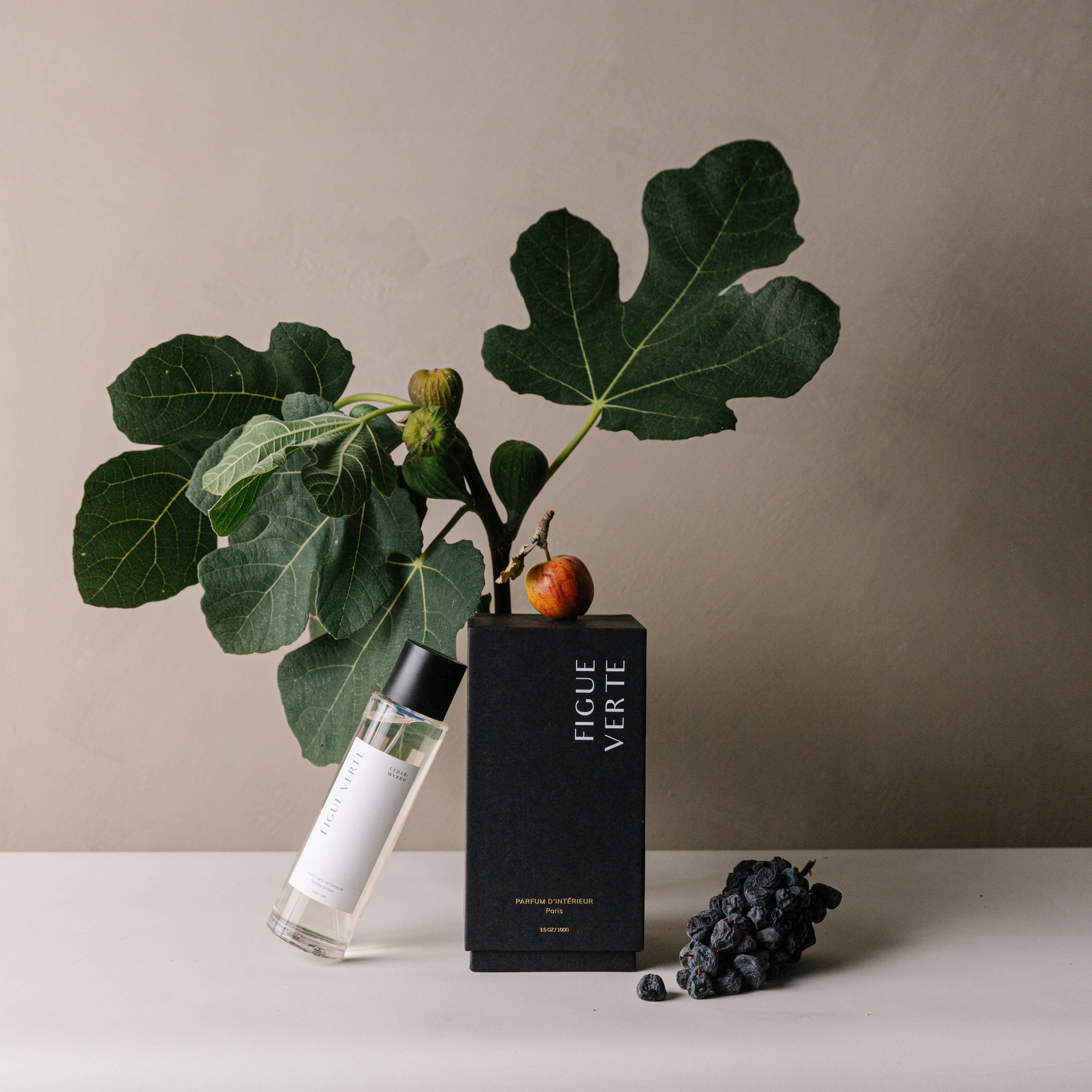 Ficelle Verte perfume bottle with a plant and fruits on a neutral background
