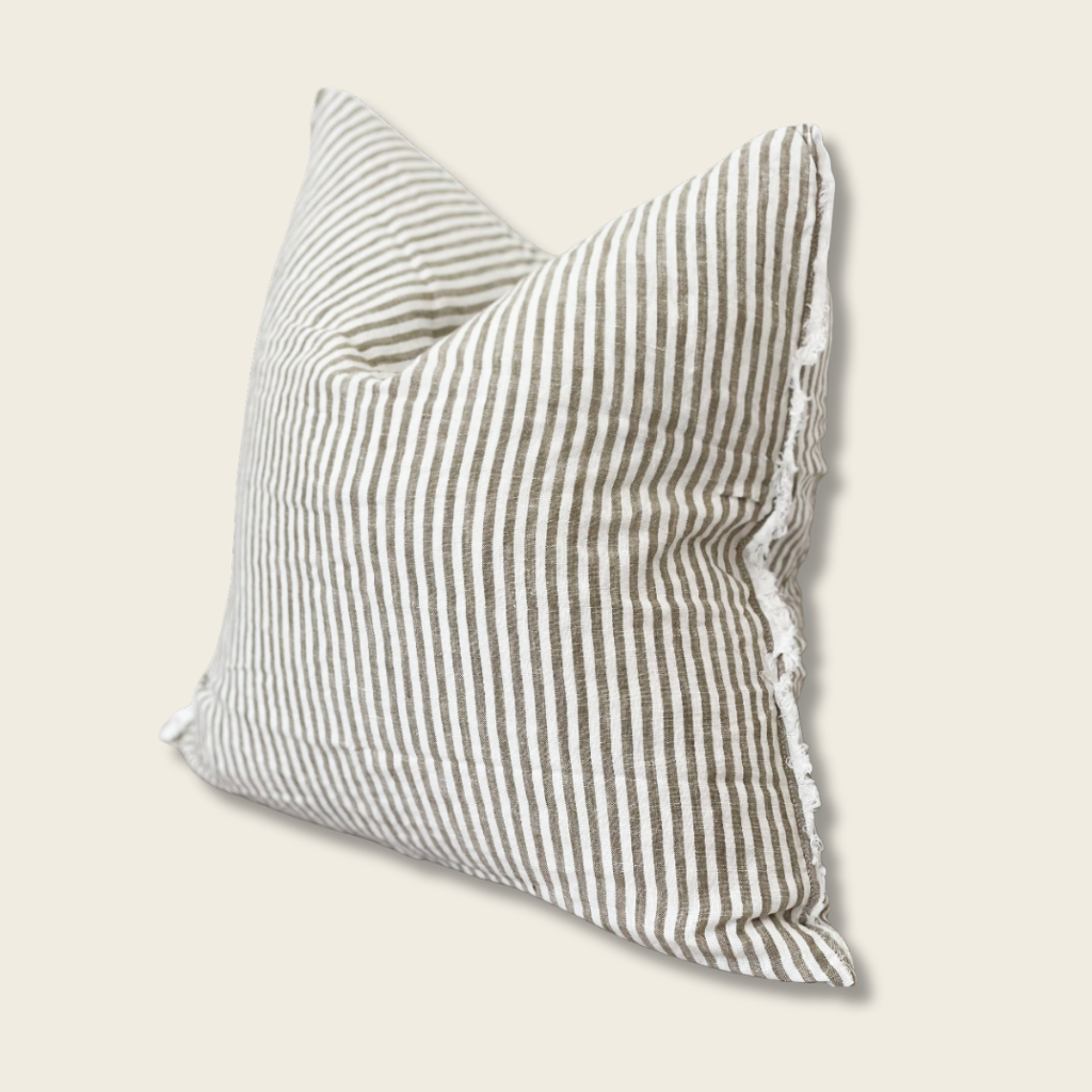 Olive pinstripe cushion with frayed edges on a beige background