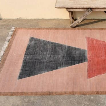 Rug with geometric design on a concrete floor