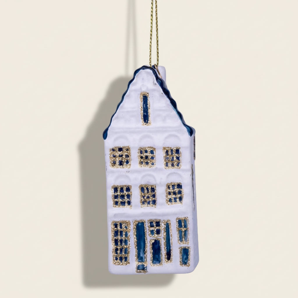 Decorative house ornament with blue and gold details on a white background