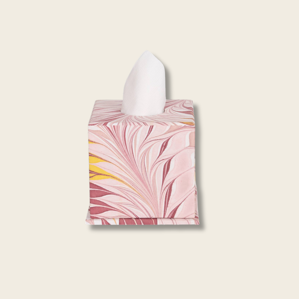 Tissue box cover with pink and yellow abstract design on a beige background