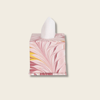 Tissue box cover with pink and yellow abstract design on a beige background