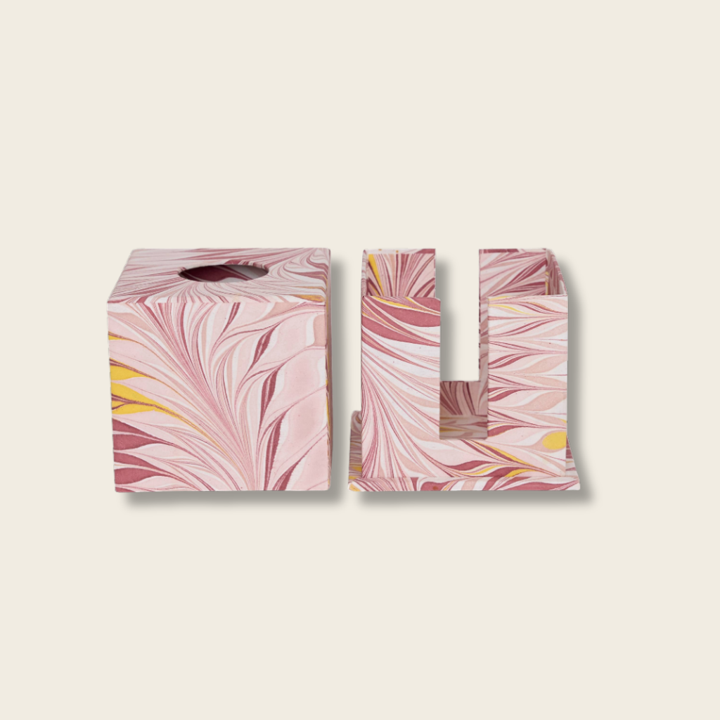Pink marbled tissue box cover with matching holder on a beige background