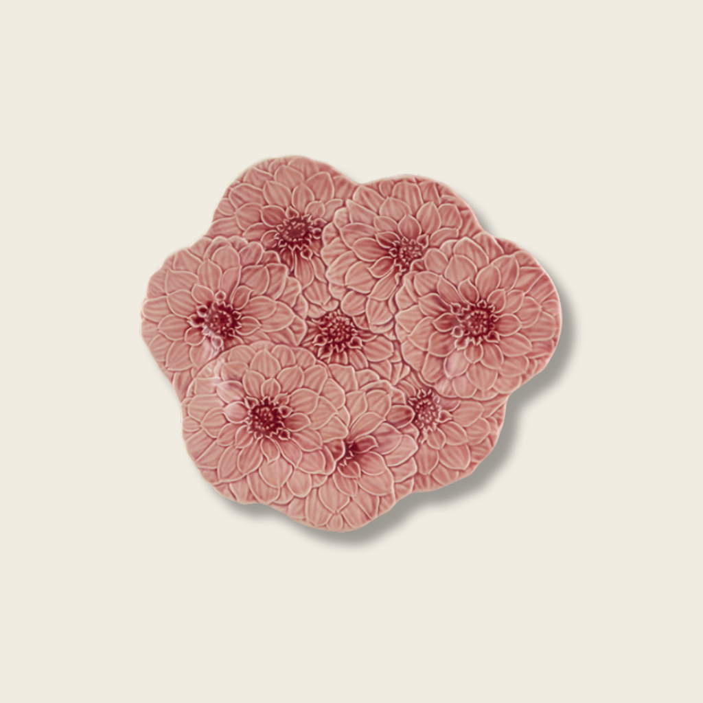 Set of four pink floral coasters on a beige background