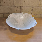 White ceramic bowl with textured surface on a wooden surface