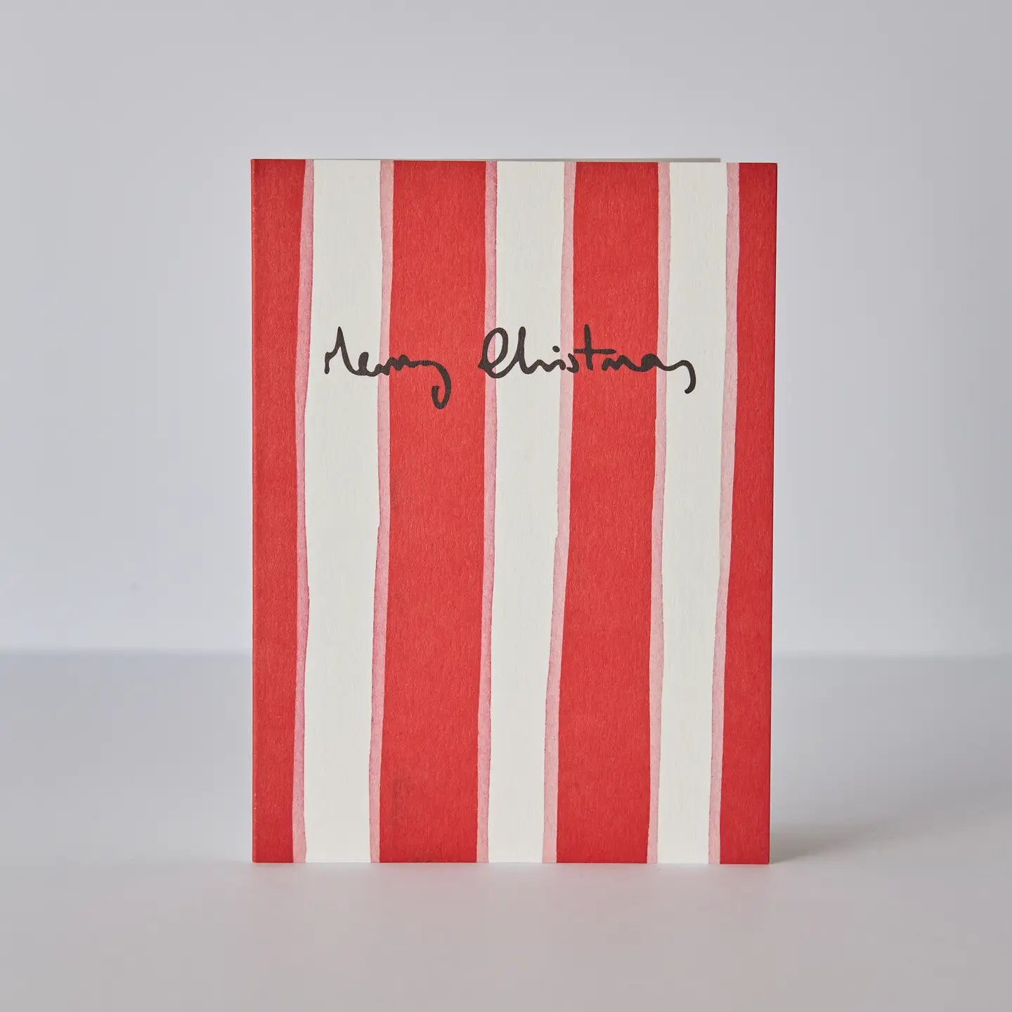 red and pink stripe card with merry Christmas slogan.