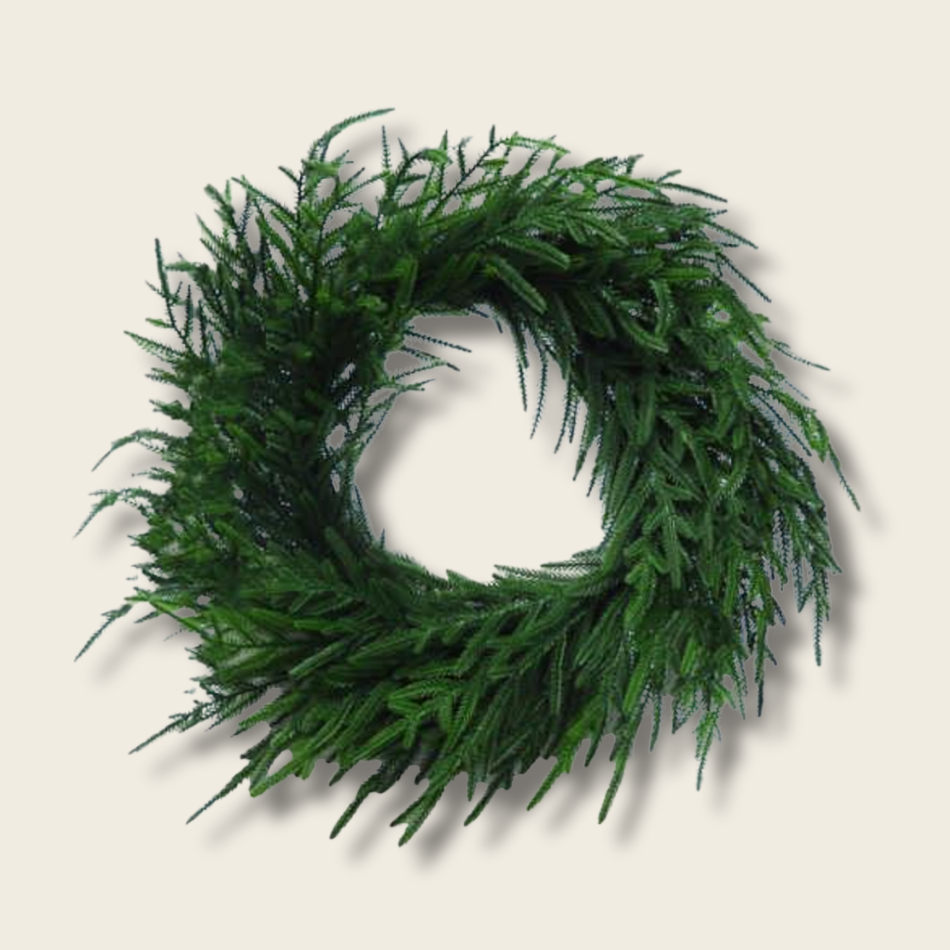 Green artificial wreath on a beige background