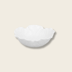 small cream cabbage leaf shaped bowl on a beige background