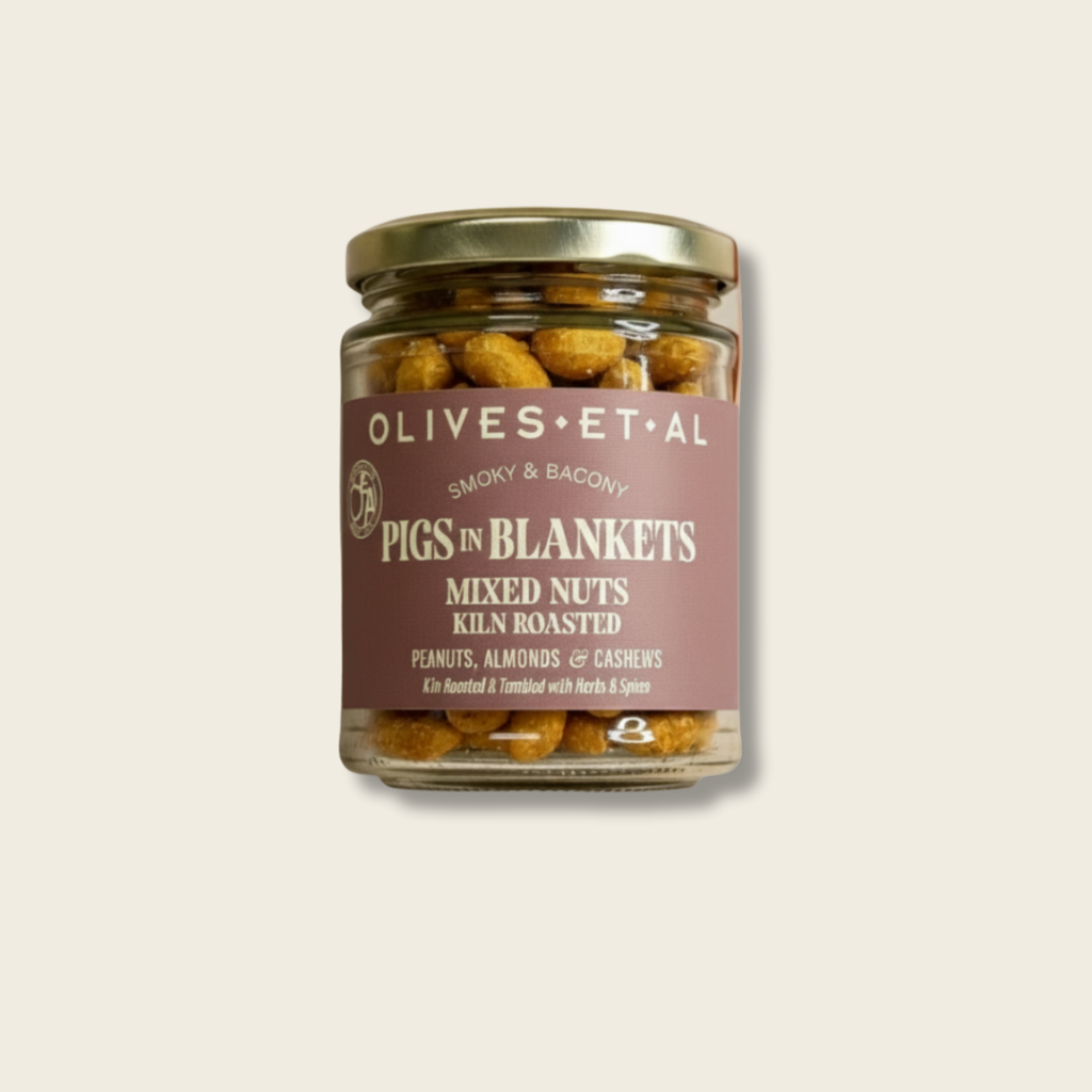 Jar of 'Pigs in Blankets' mixed nuts with a label on a light beige background