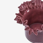 Plum Glass Pot with decorative edge on a white background