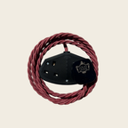 Red coiled cable with a black connector on a beige background