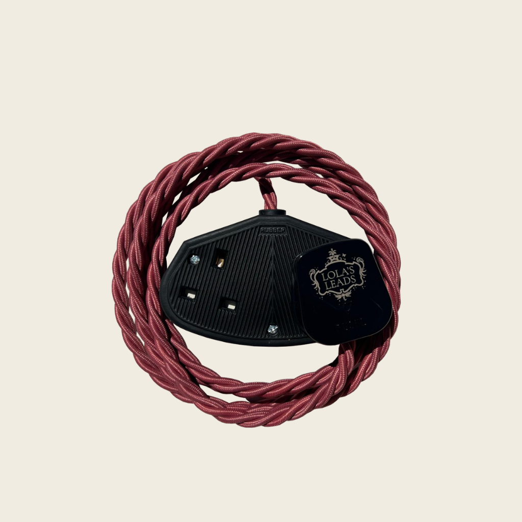 Red coiled cable with a black connector on a beige background