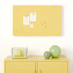 Yellow cabinet with decorative items against a white wall