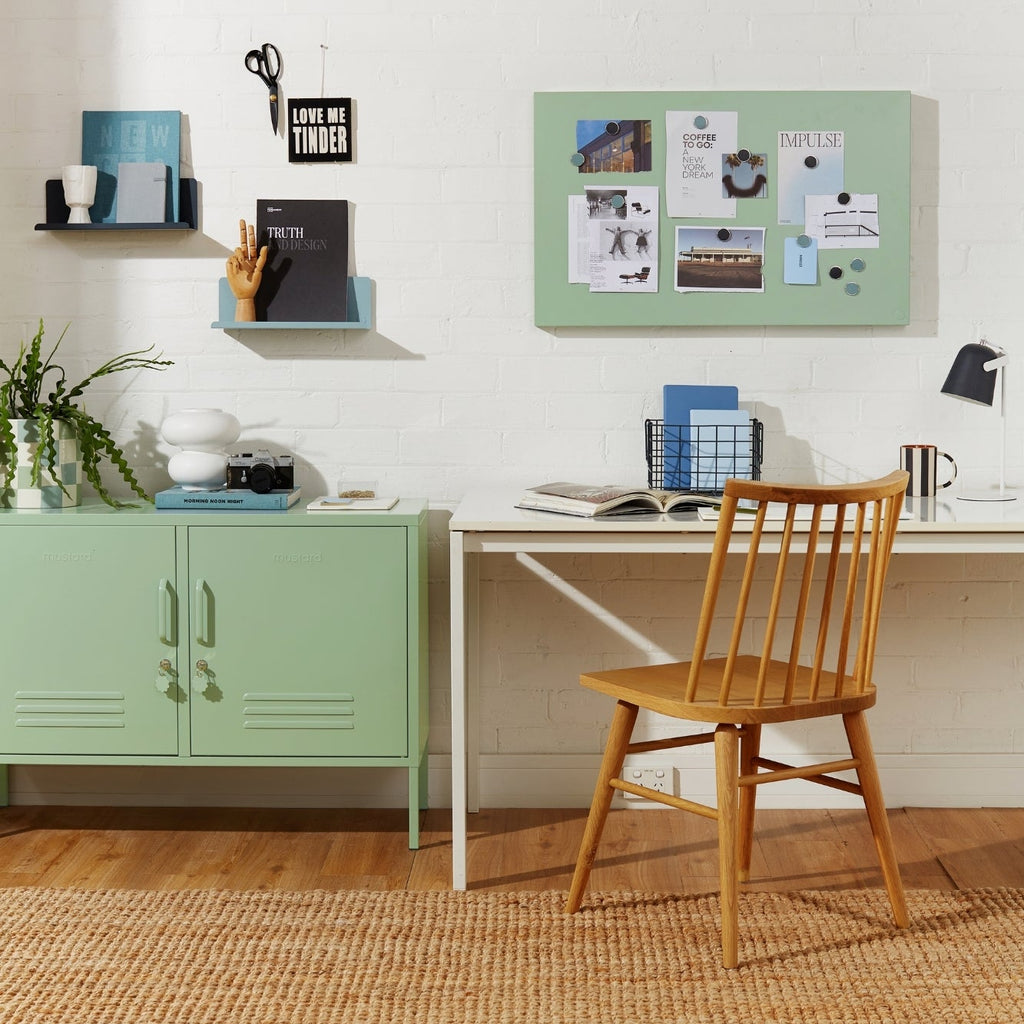 Home office with a green cabinet, desk, and chair.