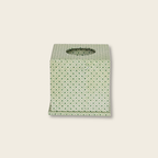 Green tissue box with diamond and dot print on beige background